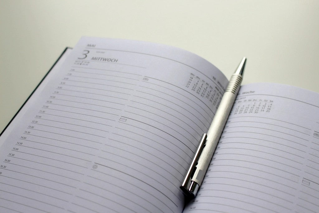 Open planner with a pen for making a busy family day more flexible