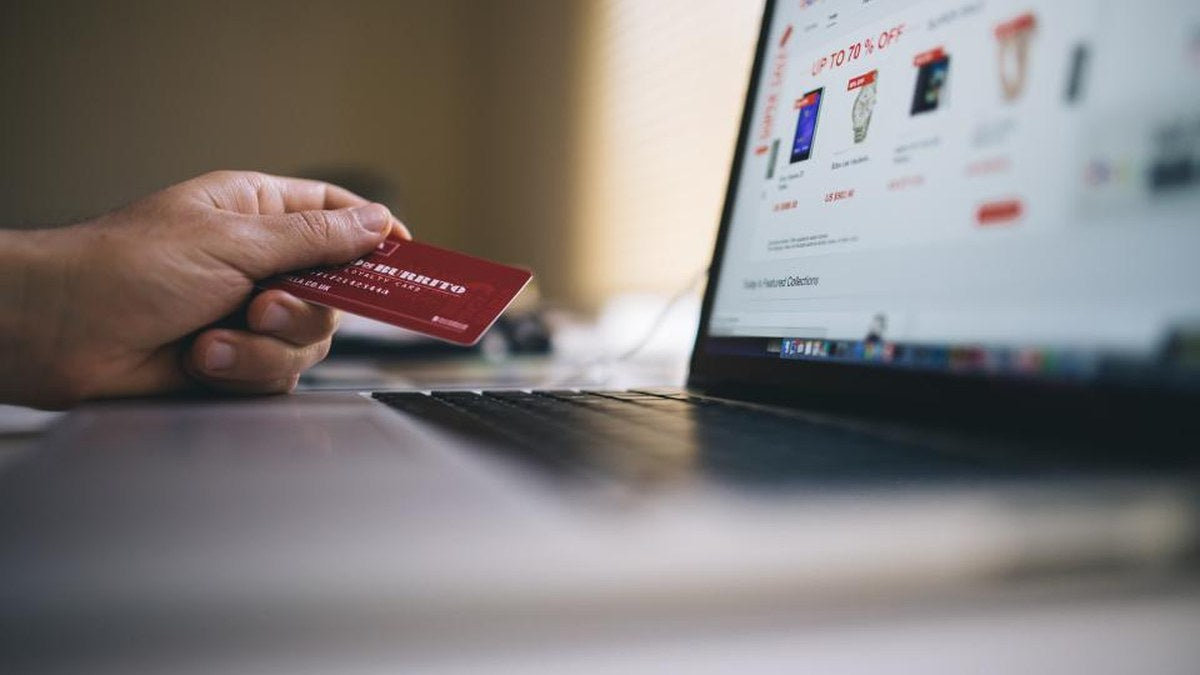 Person comparing an online product page while shopping on a laptop