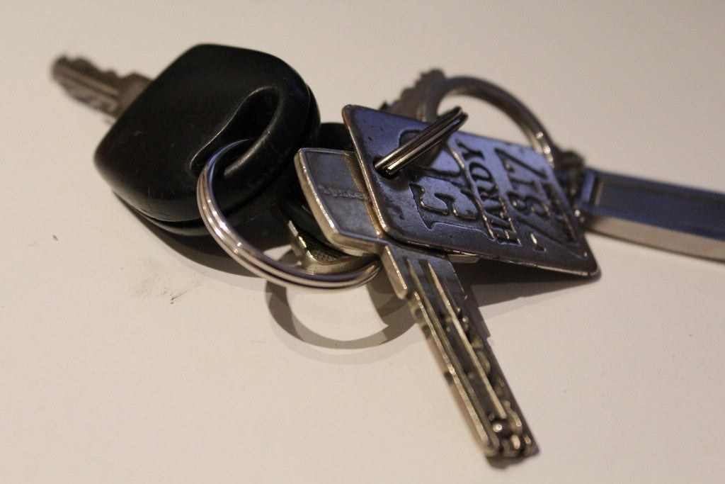 Set of everyday keys resting on a light table before leaving home