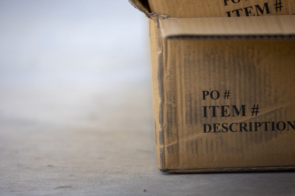 Plain cardboard package on a neutral surface ready for return planning
