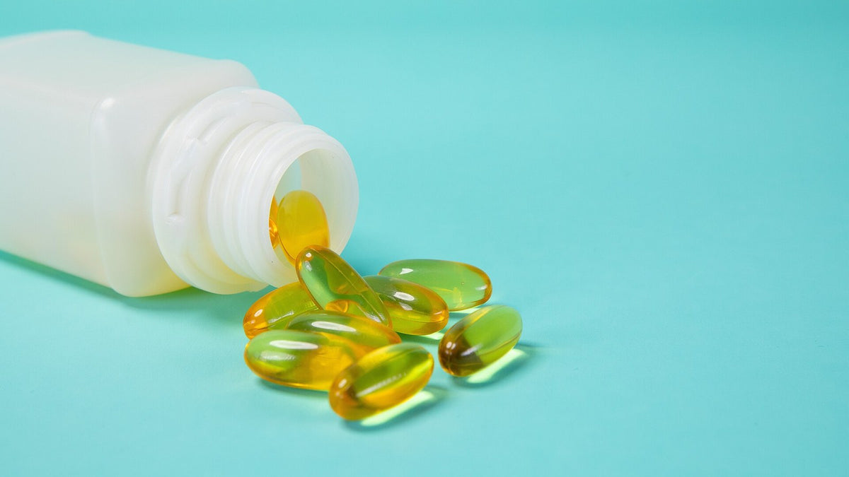 Supplement capsules beside a plain white bottle, ready for a careful label and directions review
