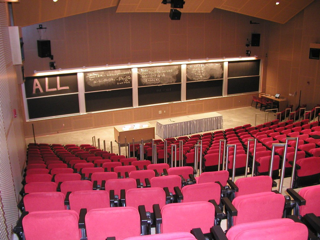 Rows of red event seats divided by clear stepped aisles