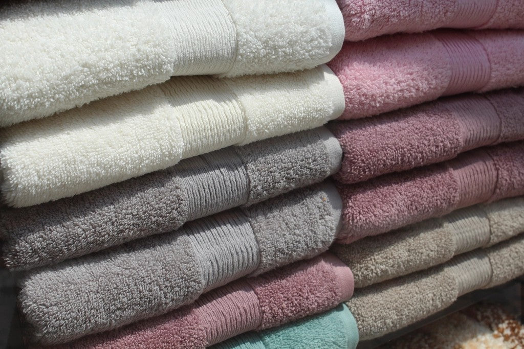 Stack of soft bath towels for a lower-pressure shower routine