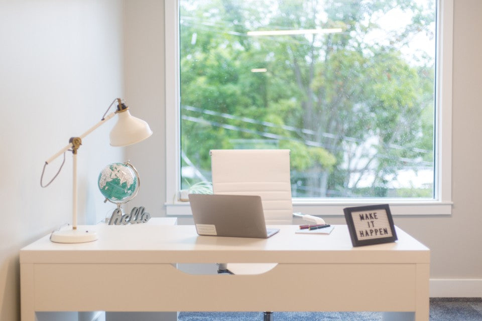 Bright home office with an open laptop and space to step away from a video meeting