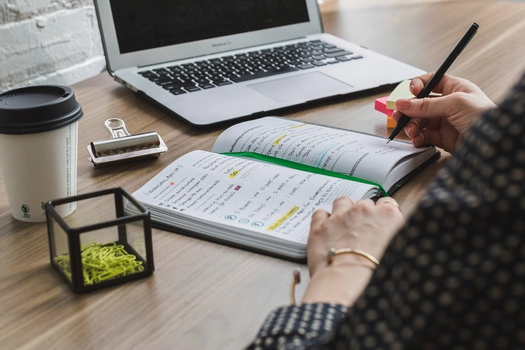 Person writing in a notebook while building a simple gut-support routine