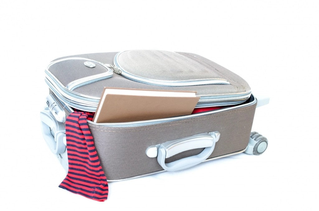 Partially packed wheeled suitcase with clothing ready for a short stay