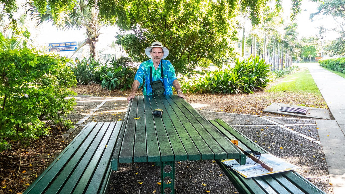A shaded picnic table in a green park, ready for a flexible outing with IBD