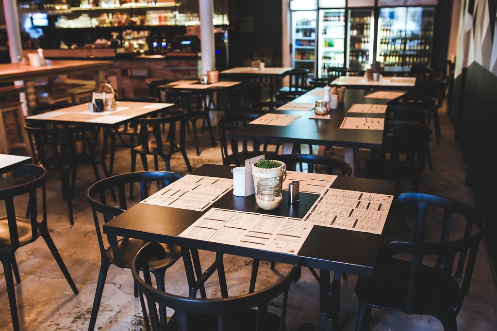 Menus arranged on a wooden table in a warmly lit restaurant