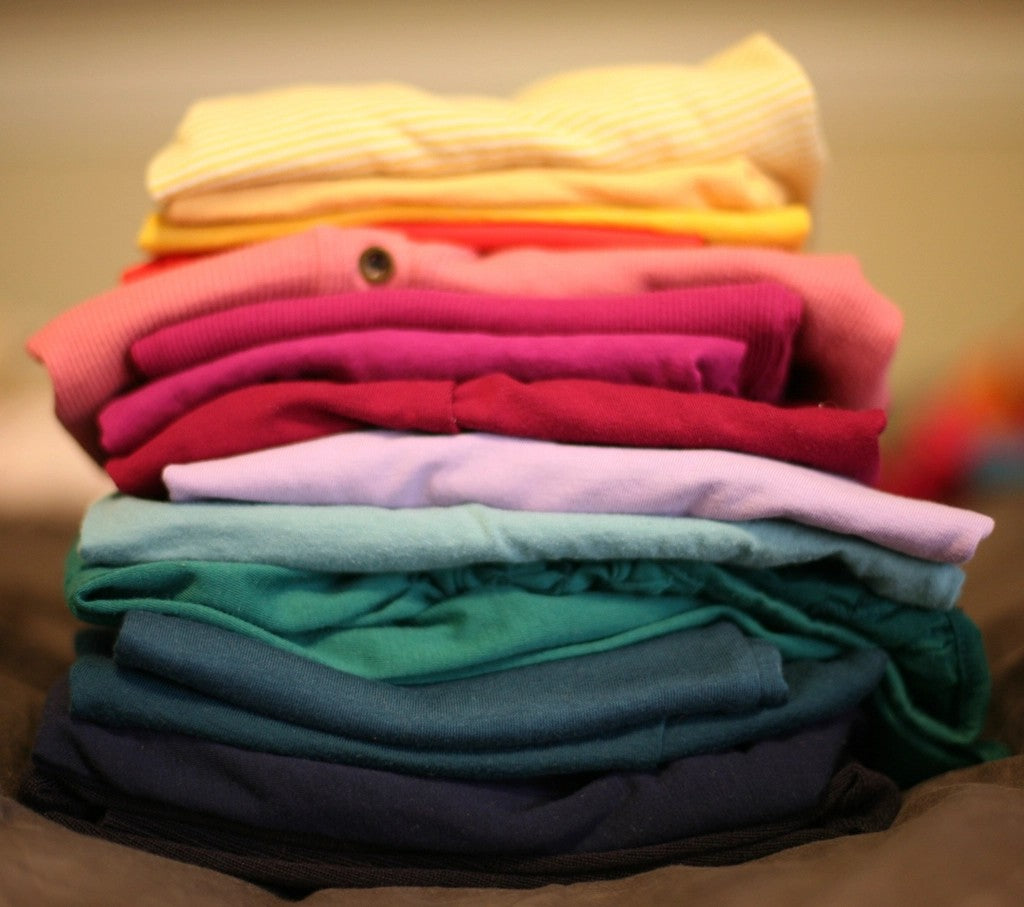 Colorful stack of folded clothes for breaking housework into smaller tasks