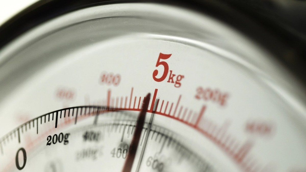 Close view of an analog scale dial representing a careful date and label check