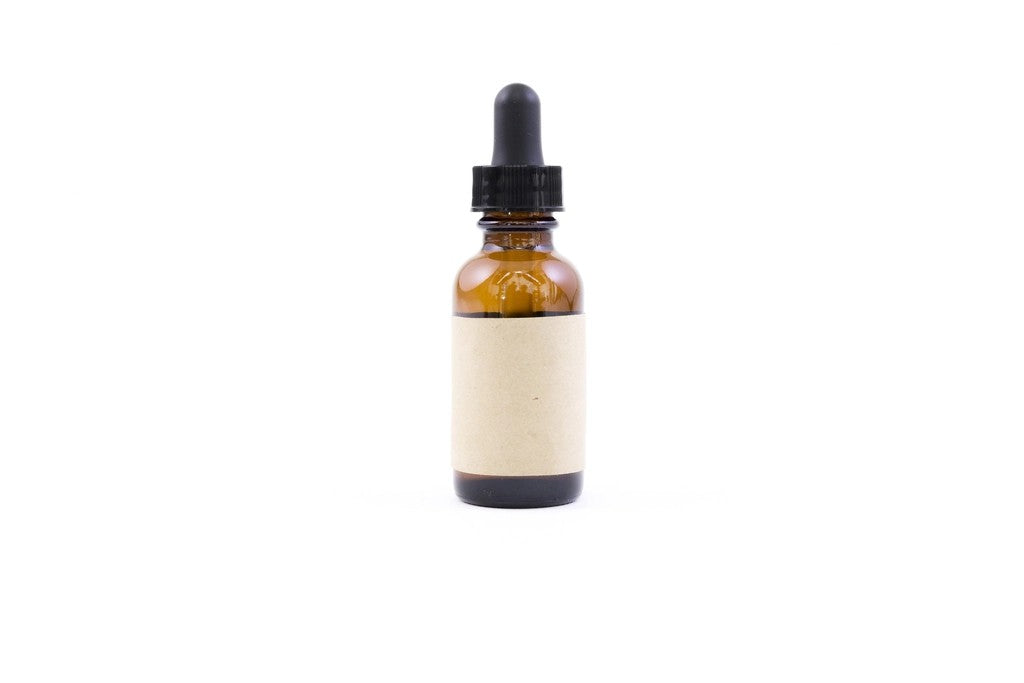 Amber bottle with a plain paper label against a white background