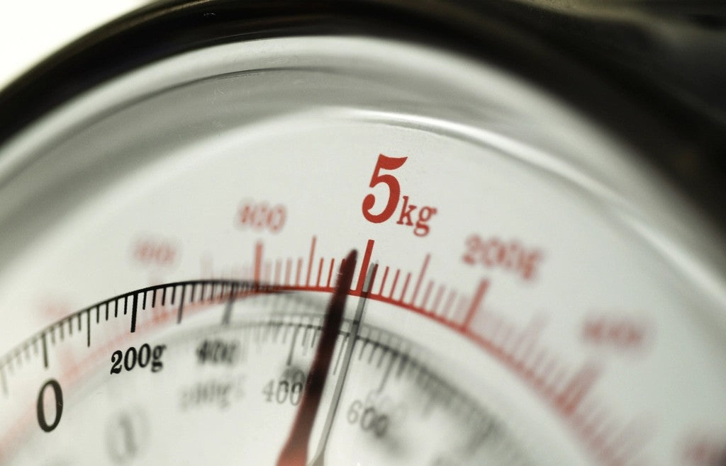 Close view of a classic scale dial for comparing serving-size numbers