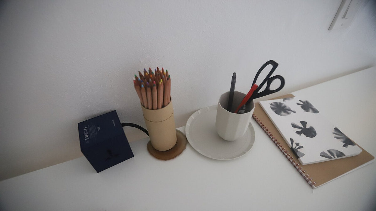 Minimal desk with a notebook and writing supplies